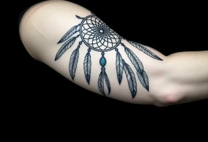 native dreamcatcher with flowing feathers and sacred beads tattoo idea