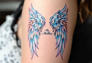 A pair of angel wings in light blue and lavender with “My Mother” between them. tattoo idea