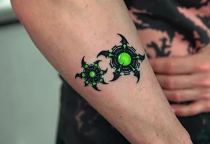 A sleek exo-arm design in carbon fiber black and electric green, with overlapping panels mimicking armor across the fingers. tattoo idea