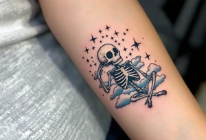 Tim Burton’s dreaming skeleton lies in a field of gray-blue clouds and faintly glowing stars. tattoo idea