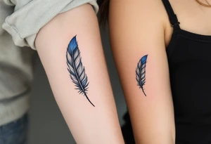 Two matching man and woman black feather tattoos with blue tips. tattoo idea