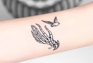 Skeleton hand reaching out of the ocean for a flying swallow in the Sailor Jerry style tattoo idea