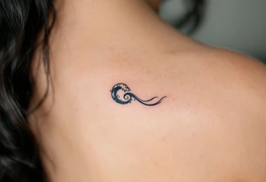 A tiny black wave with delicate shading curls on the side of the finger, simple and elegant. tattoo idea
