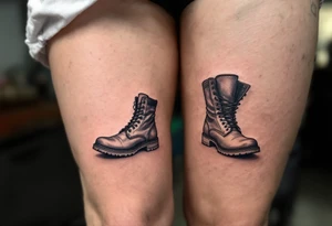 A pair of boots—one large, one tiny—side by side, outlined in black with a faint dusty blue shadow for depth. tattoo idea