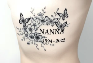 flowers and butterflies with the name “NANA” and the date “1954-2022” mixed all together on the side of the rib cage tattoo idea