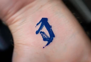 Brushstroke-style "J" in deep indigo, resembling Japanese ink calligraphy. tattoo idea