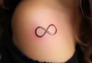 Two interlocking infinity symbols in gold and rose pink, representing eternal mother-daughter love. tattoo idea