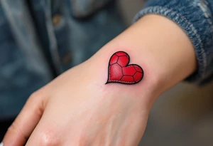 A small heart-shaped red soccer ball stitched like leather, symbolizing love for the game. tattoo idea