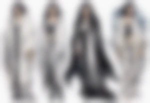 a middle aged woman with black hair with streak of white dressed in a black and silver cloak tattoo idea