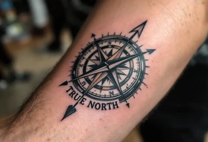 Rustic half compass with a long native American arrow pointing at my wrist with the words “True North” tattoo idea