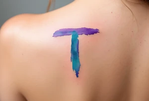 A watercolor-style "T" in shades of turquoise and purple, blending like paint strokes. tattoo idea