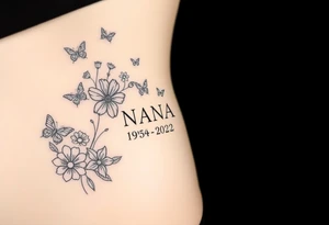 flowers and butterflies with the name “NANA” and the date “1954-2022” mixed all together on the side of the rib cage tattoo idea