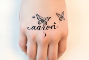 a hand tattoo with the name aaron, add some butterflies and a semicolon tattoo idea