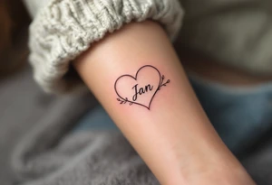 A delicate, outline heart with a flowing ribbon, containing the name "Jan" in elegant cursive, with soft pastel pink and gold accents. tattoo idea