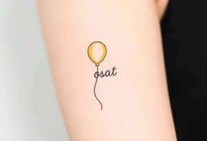small yellow balloon without string 
with letters osaat on bicep tattoo idea