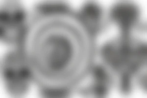 Hourglass made of skulls on a black and white spiral with text momento mori tattoo idea
