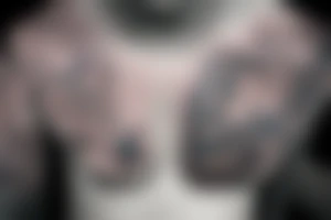 A womens chest tattoo with a starry night with a mermaid in the ocean getting lit by the nightlight tattoo idea