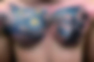 A winged chest tattoo with a starry night with a mermaid in the ocean tattoo idea