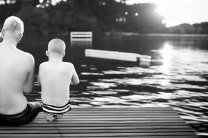 dad and son sitting on dock watching sunset tattoo idea