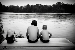 dad and son sitting on dock watching sunset tattoo idea