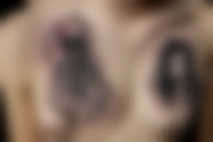 black widow with a heart hanging from a thread tattoo idea