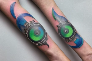 The cog bangle from Final Fantasy 7 with one green and one blue materia inserted into the materia slots tattoo idea