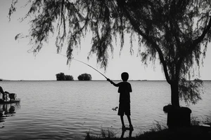 A Boy fishing by a lake with his grandfather. they are surrounded by trees with one bird sitting in a tree. There is a woman dancing beside them near an old fashioned music player tattoo idea