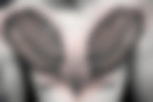 neck tattoo, in the middle a realistic eye in a triangle surrounded by wings, a line down towards the chest and the word chaos above the tattoo tattoo idea
