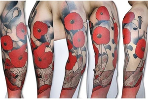 A poppy flower with a large map back drop tattoo idea