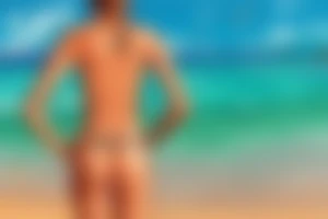 Woman is standing on a Caribbean Beach with Sunshine on my lower back tattoo idea