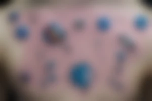 the astronaut holds a string at the end of which are gel balls, each ball symbolizes a planet in the solar system, that is, 1 ball - 1 planet.  It's all against the backdrop of space tattoo idea