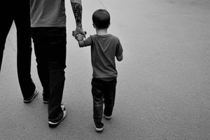 Father and son walk hand in hand. Full-length. view from behind tattoo idea