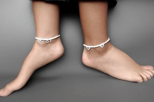 A cute little anklet around the ankle tattoo idea