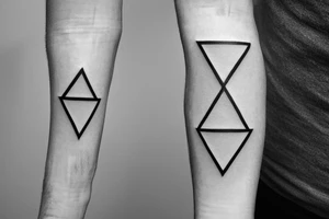 Triangle with two parallel lines crossing it parallel to the base. Small. Simple minimalist tattoo idea