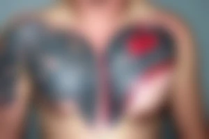 Zipper down the middle of chest exposing the inside of the chest cavity.
Main feature being the heart which has had surgery, so needs to look medically repaired. tattoo idea