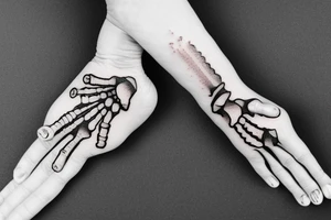 skeleton hand doing the rock-on sign tattoo idea