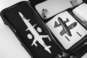 a minimal tatoo shows an airplane flying out of a suitcase to travel tattoo idea