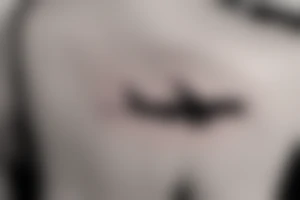 a minimal tatoo shows an airplane flying out of a suitcase to travel tattoo idea