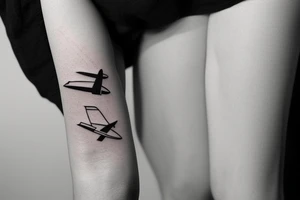 a minimal tattoo shows an airplane flying out of a suitcase to travel tattoo idea