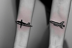 a minimal tattoo shows an airplane flying out of a suitcase to travel tattoo idea