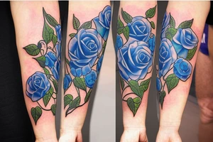 On the inside of a forearm, there is a long broken sword with three blue roses and vines. tattoo idea